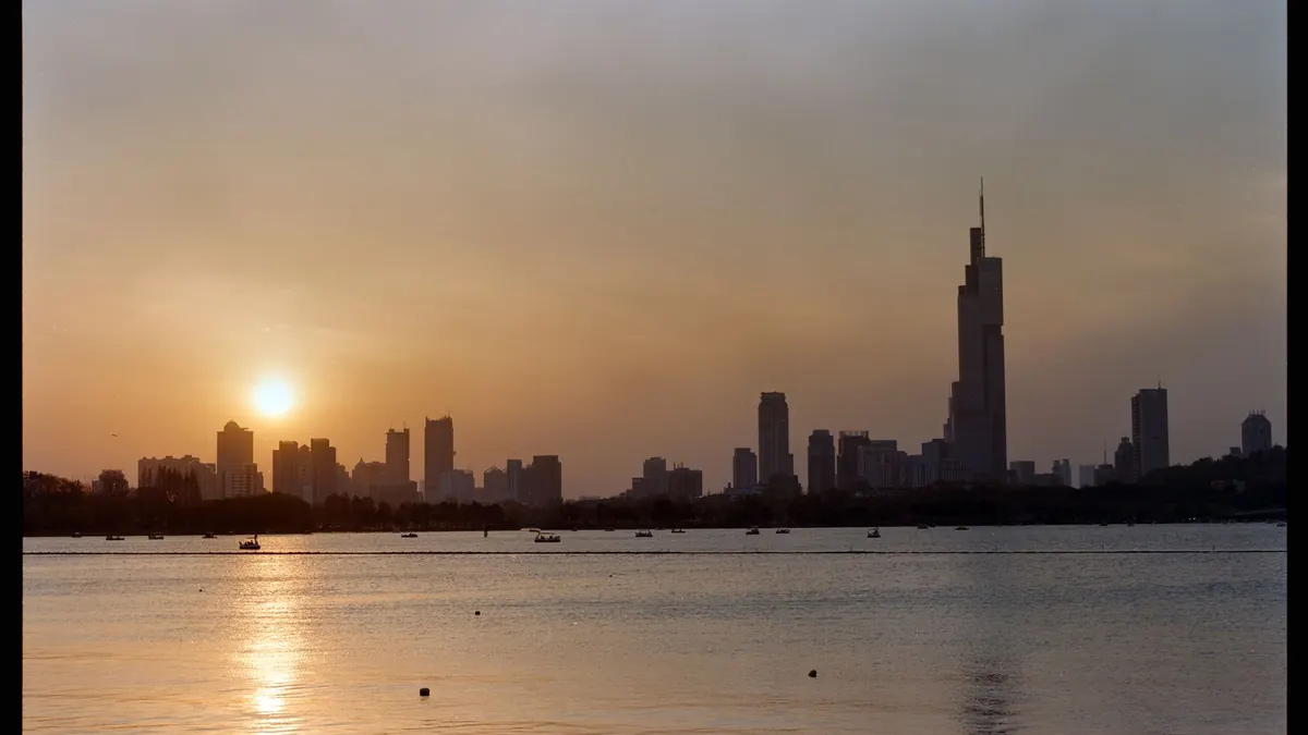 Nanjing skyline at sunset across Xuanwu Lake, with Zifeng Tower